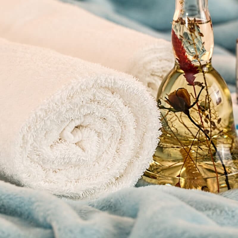 massage therapy essential oils at a spa with a towel