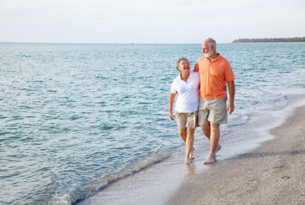 seniors walking on the beach