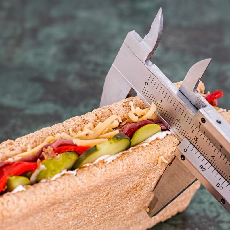 a sandwich being measured